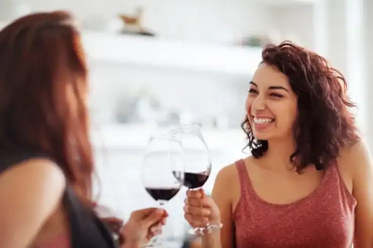 two women having a glass of wine