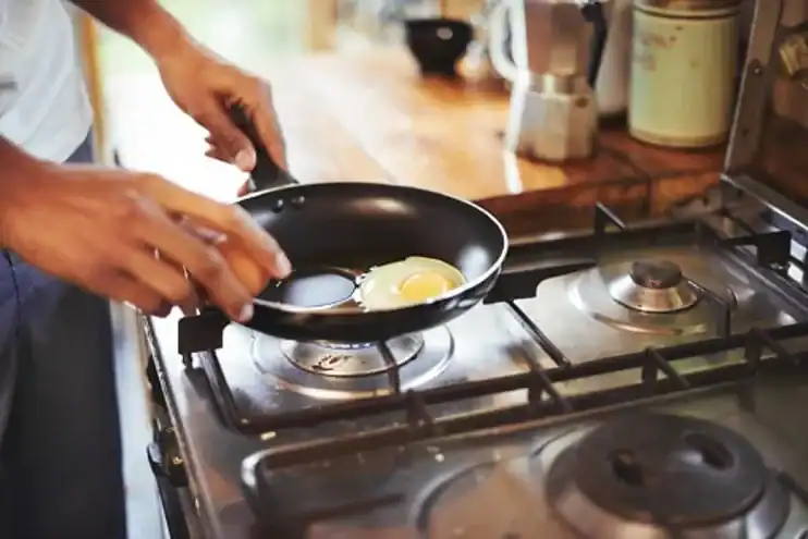 man cooking eggs