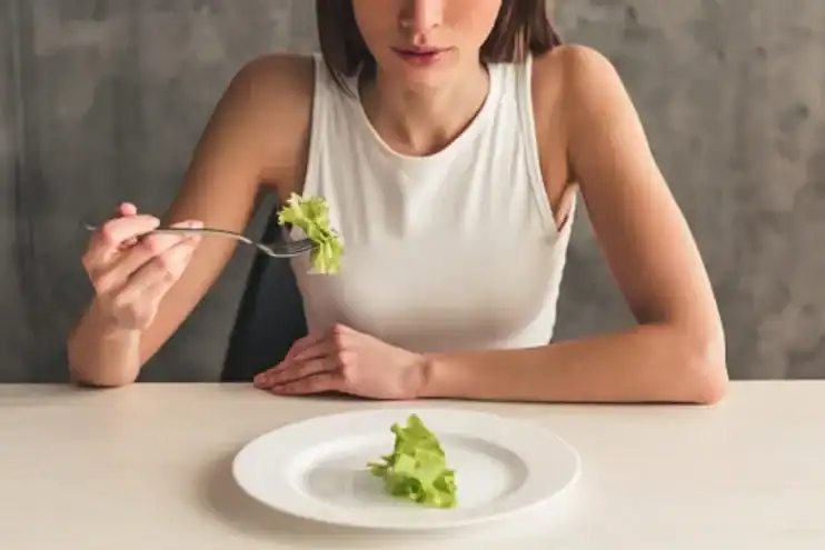 woman with a plate of lettuce