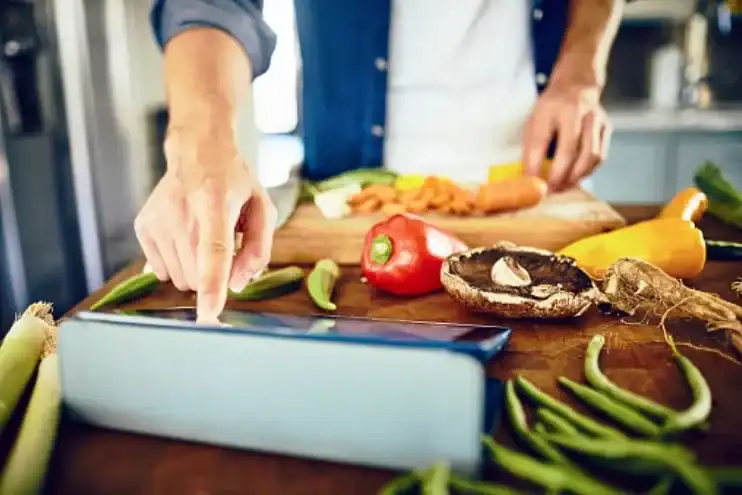 Man prepping meals and tracking calories