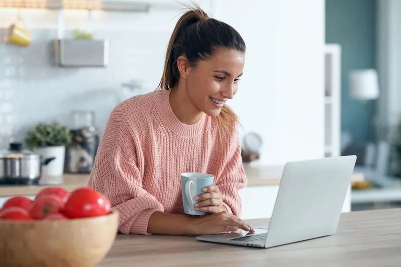 woman on laptop viewing momentum membership