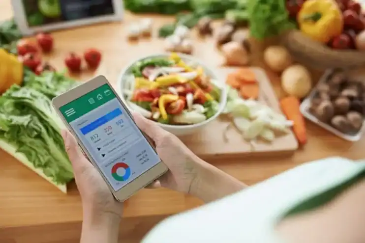 A person is using a smart phone to look at a food menu.